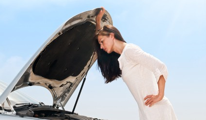 Woman Looking Under Hood of Car in Tampa, FL